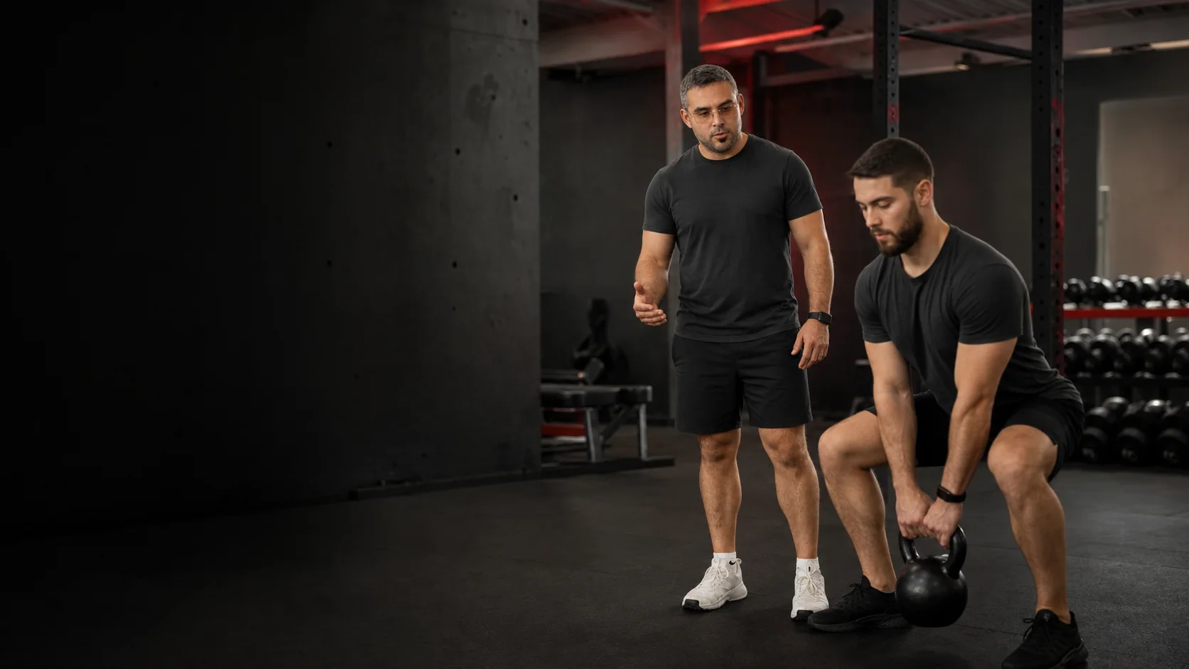 Anthony Marabella coaching a client through a strength exercise in a Montréal gym